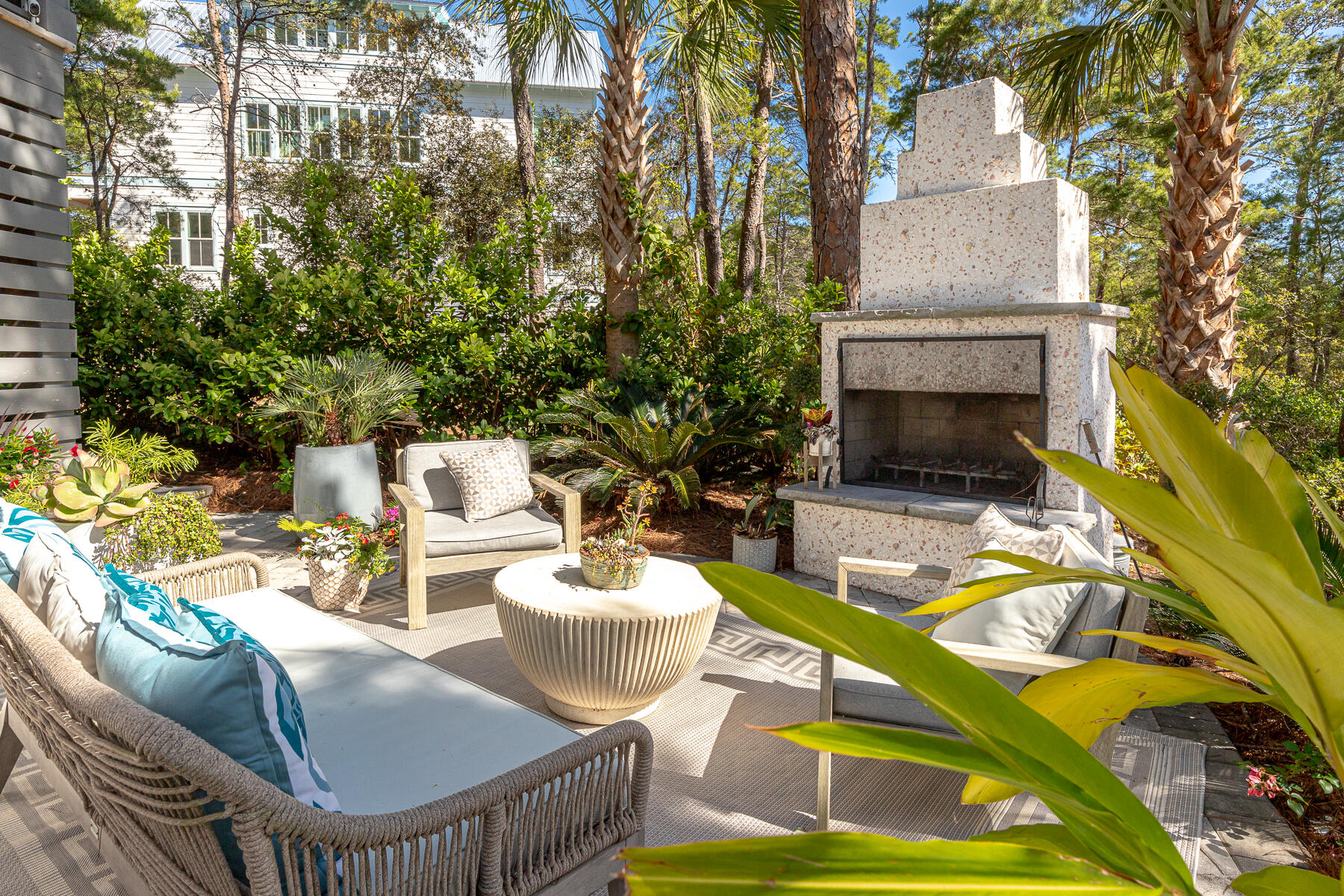 363 Matt's Way Santa Rosa Beach, FL 32459 - Photo 2 of 51 a view of a patio with table and chairs potted plants and a palm tree