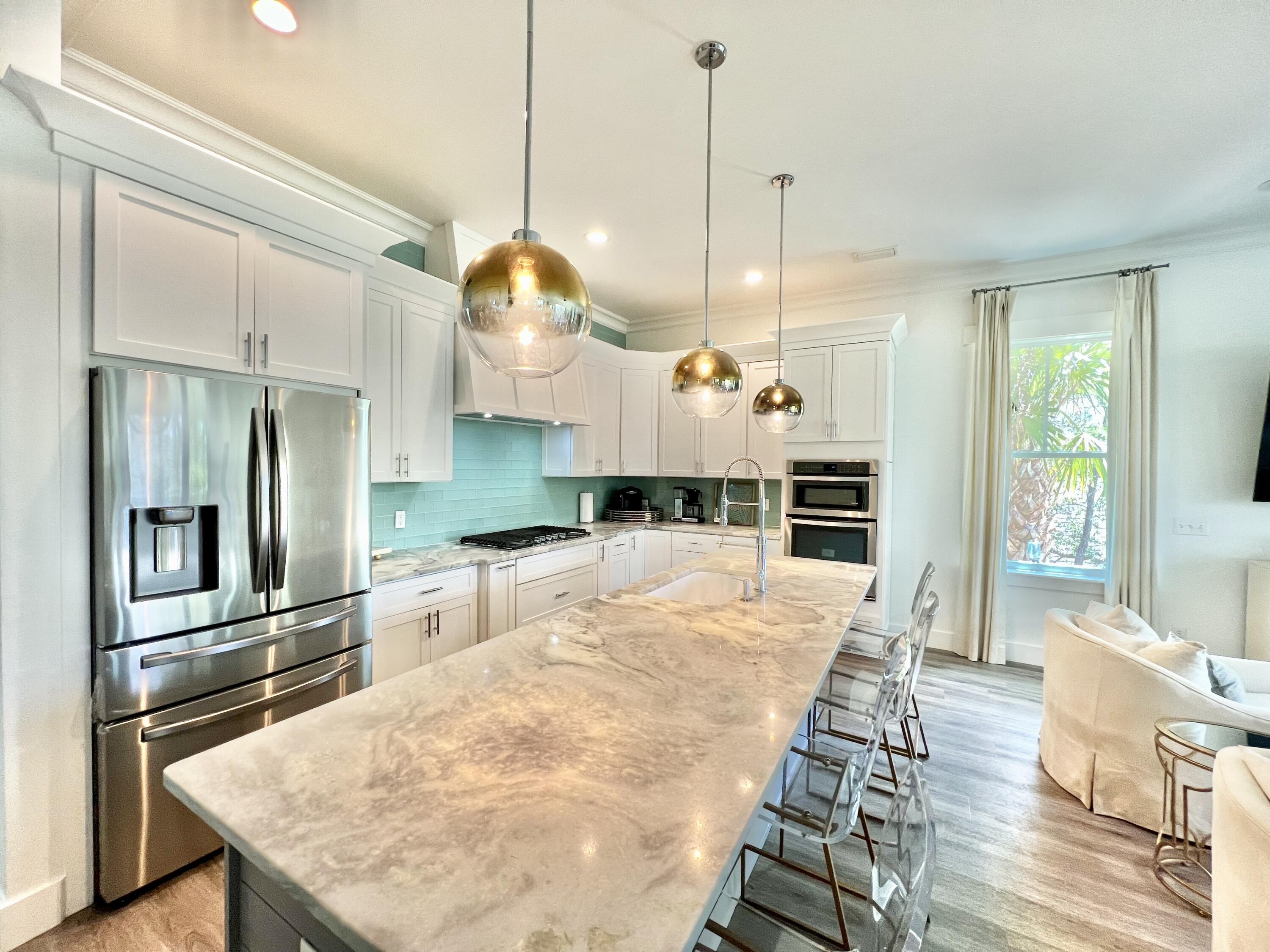 363 Matt's Way Santa Rosa Beach, FL 32459 - Photo 5 of 51 a large kitchen with kitchen island a counter space a sink appliances and cabinets