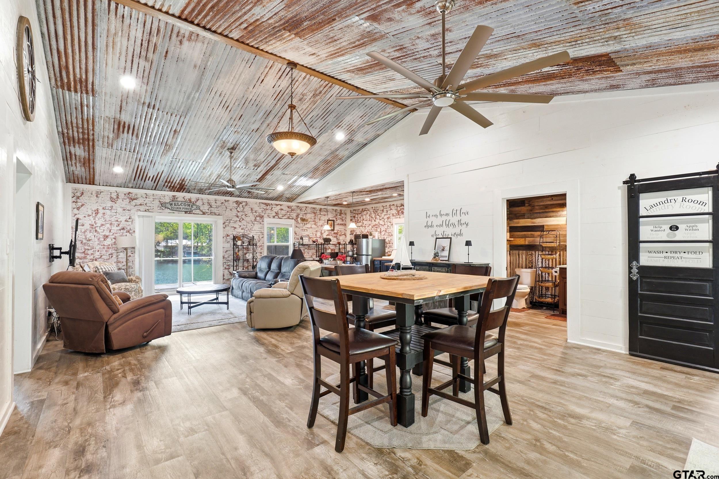 132 King George Road Scroggins, TX 75480 - Photo 11 of 35 a dining room with furniture a floor to ceiling window and wooden floor