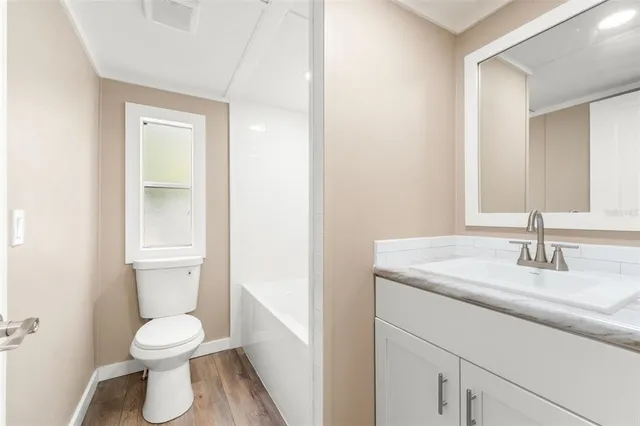 a bathroom with a toilet sink and a mirror