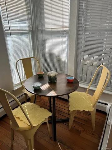 a bed sitting in a bedroom next to a window and a lamp