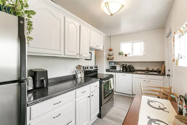 a kitchen with stainless steel appliances and white cabinets