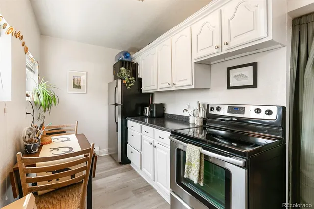 a kitchen with stainless steel appliances granite countertop a stove and a refrigerator