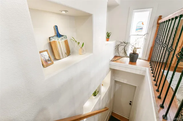 a living room with furniture and a dining table with kitchen view