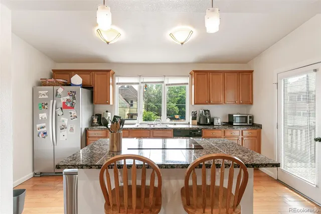 a kitchen with sink a window and cabinets