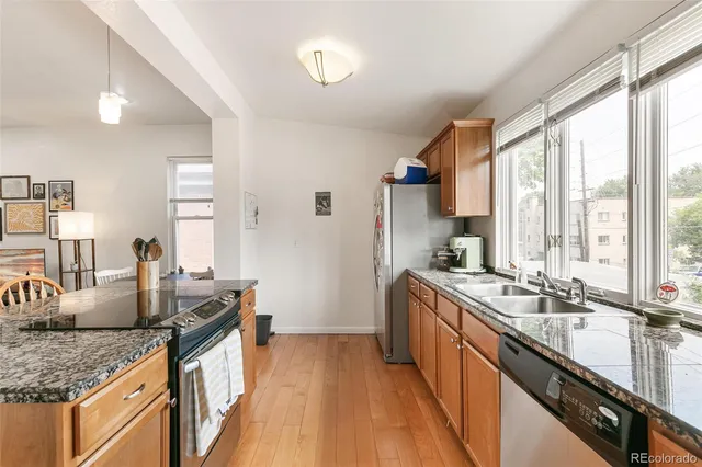 a kitchen with granite countertop attached living room