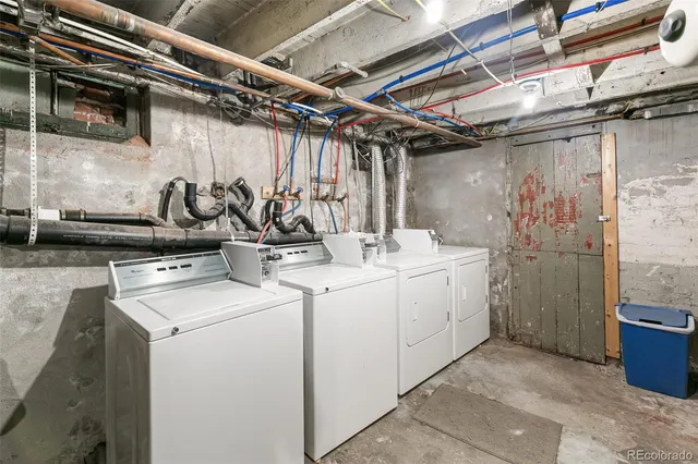a utility room with multiple dryer and washer