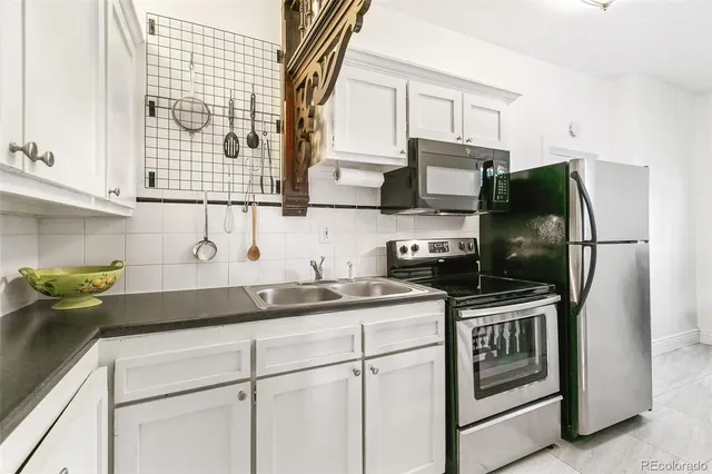 a kitchen with stainless steel appliances granite countertop a stove and a sink