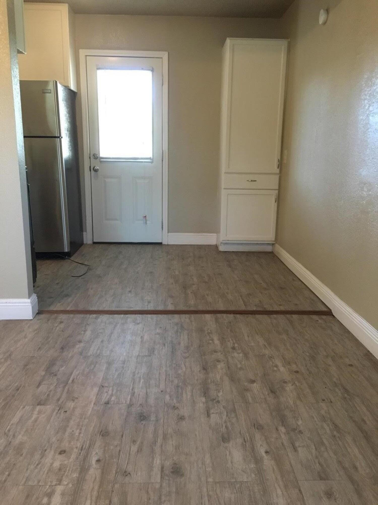 4501 45th Street Lubbock, TX 79414 - Photo 4 of 9 an empty room with a wooden door and glass door