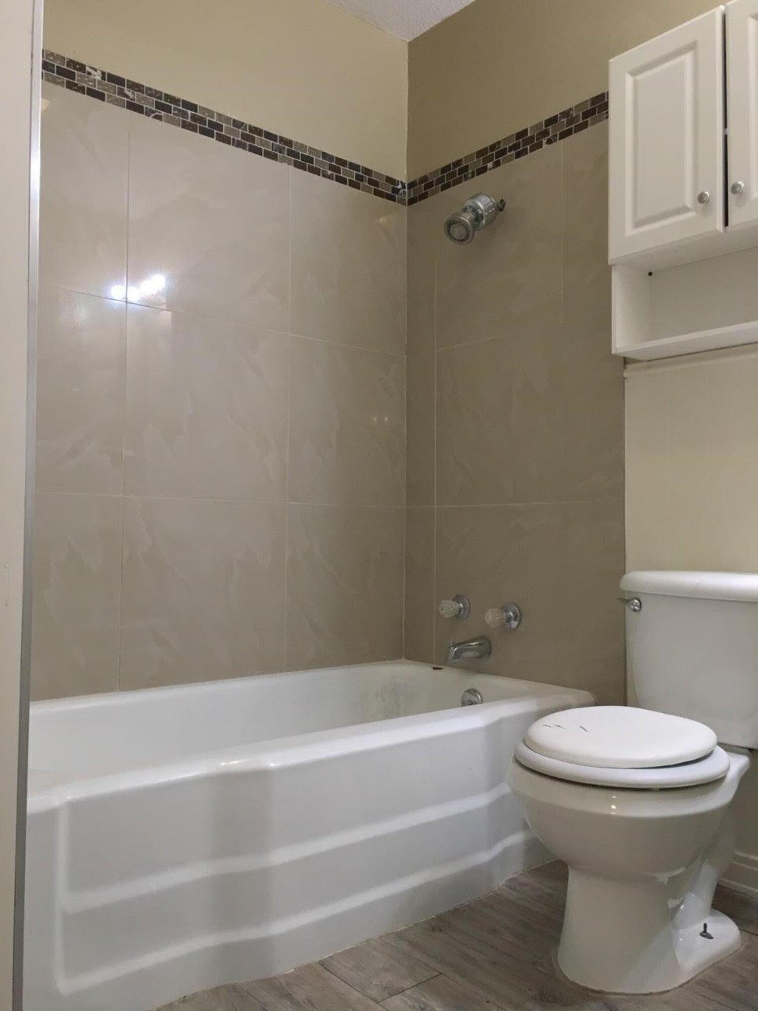 4501 45th Street Lubbock, TX 79414 - Photo 8 of 9 a bathroom with a toilet and a bathtub