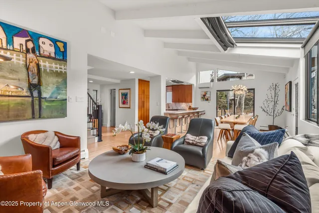 a kitchen with stainless steel appliances granite countertop a sink and a refrigerator
