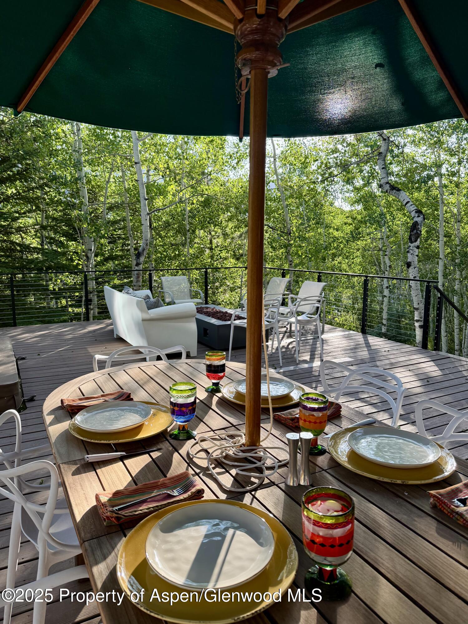 262 Eastwood Road Aspen, CO 81611 - Photo 45 of 46 a table and chairs are sitting on the wooden deck