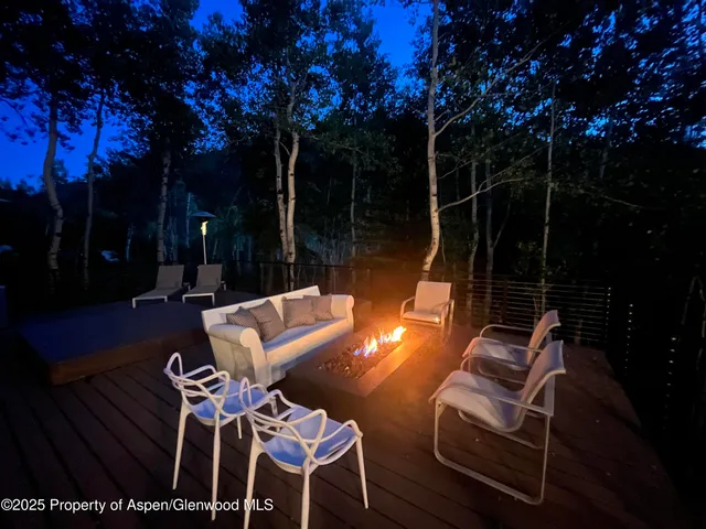 a living room with fireplace furniture and a large window