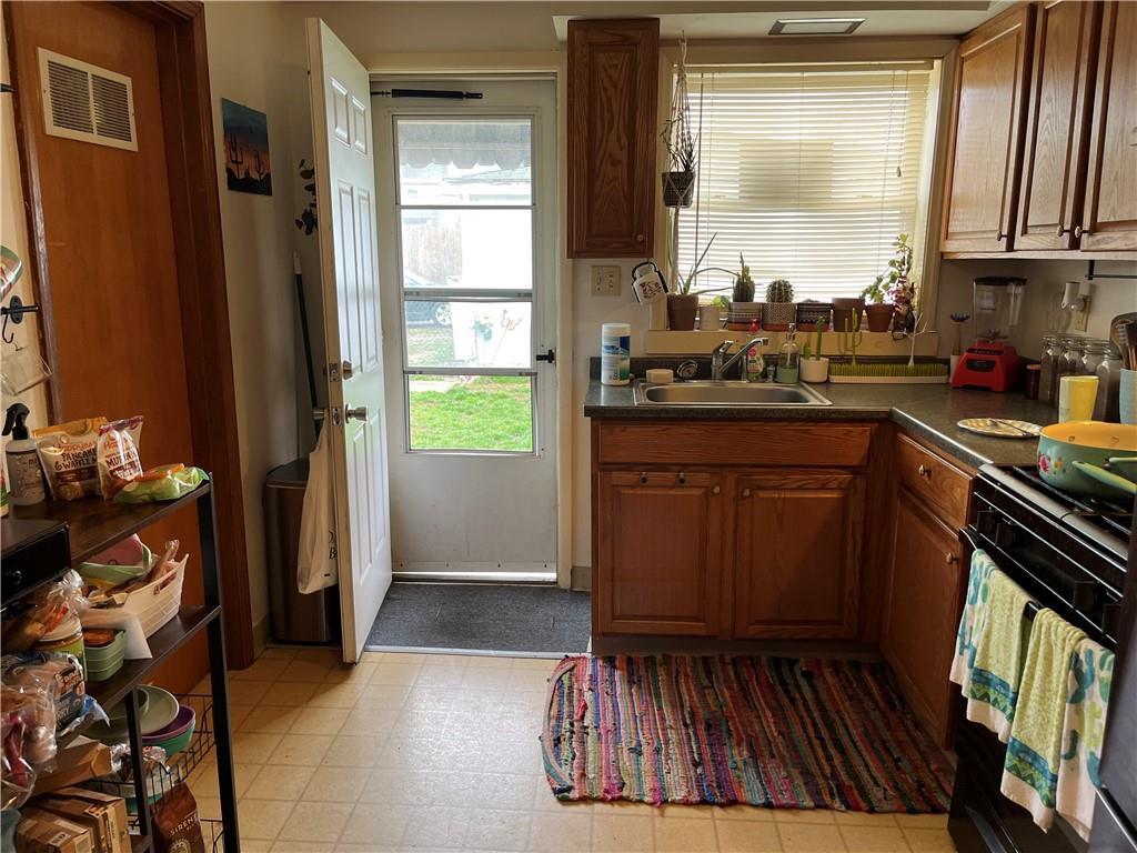 613-615 Bank Street Carnegie, PA 15106 - Photo 15 of 25 a kitchen with sink a refrigerator and window