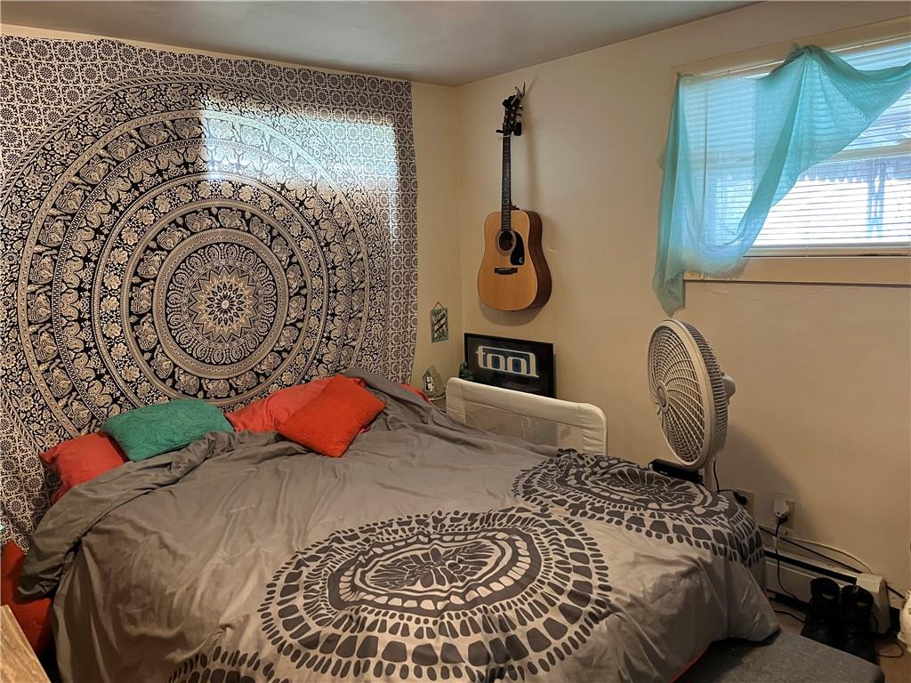 613-615 Bank Street Carnegie, PA 15106 - Photo 17 of 25 a bedroom with a bed and a chandelier