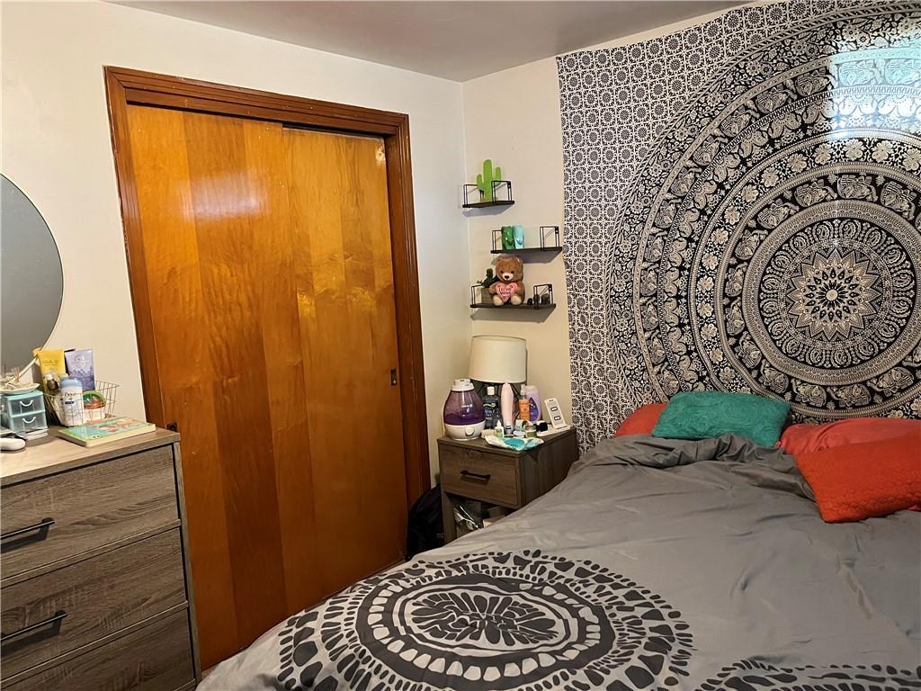 613-615 Bank Street Carnegie, PA 15106 - Photo 18 of 25 a bedroom with a bed and a dresser