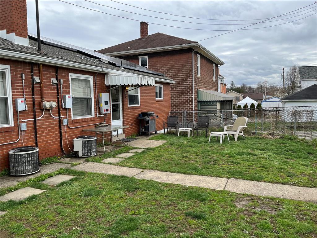 613-615 Bank Street Carnegie, PA 15106 - Photo 21 of 25 a front view of a house with a yard table and chairs