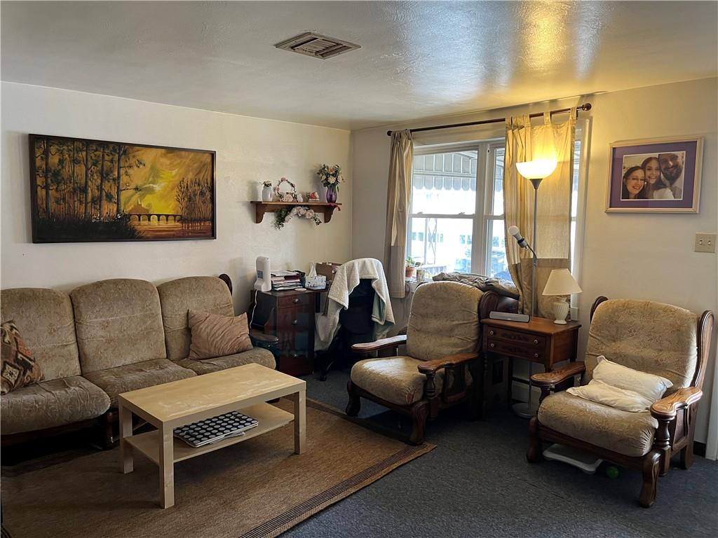 613-615 Bank Street Carnegie, PA 15106 - Photo 4 of 25 a living room with furniture a couch and two window