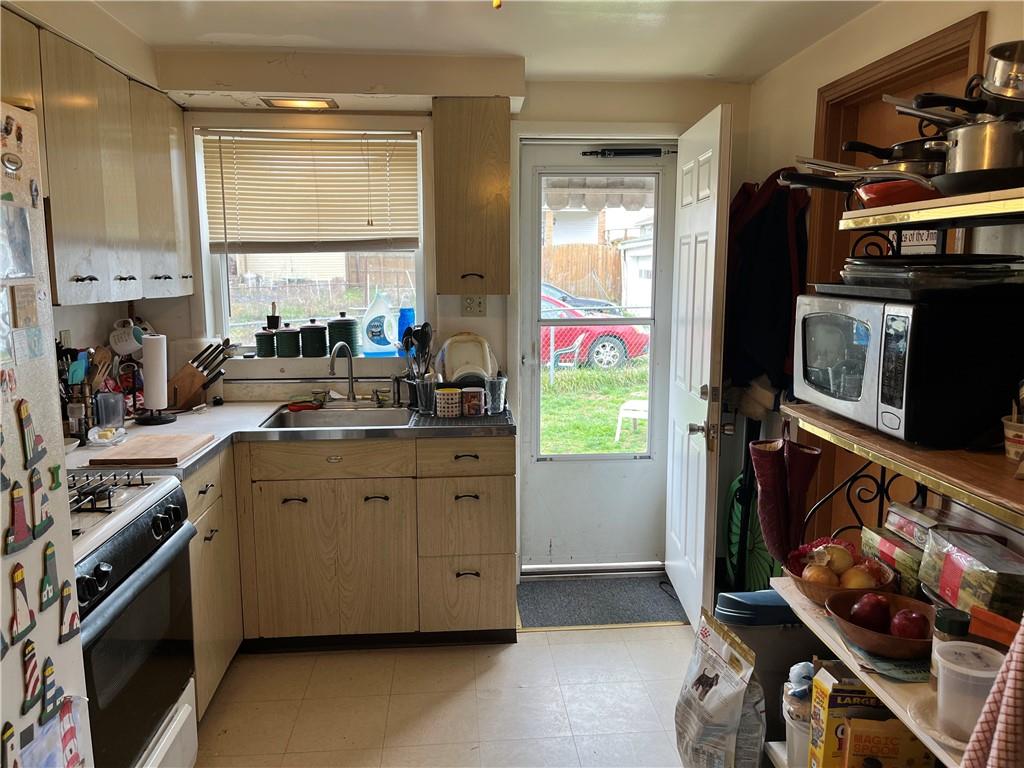 613-615 Bank Street Carnegie, PA 15106 - Photo 5 of 25 a kitchen with stainless steel appliances a stove a sink and a refrigerator