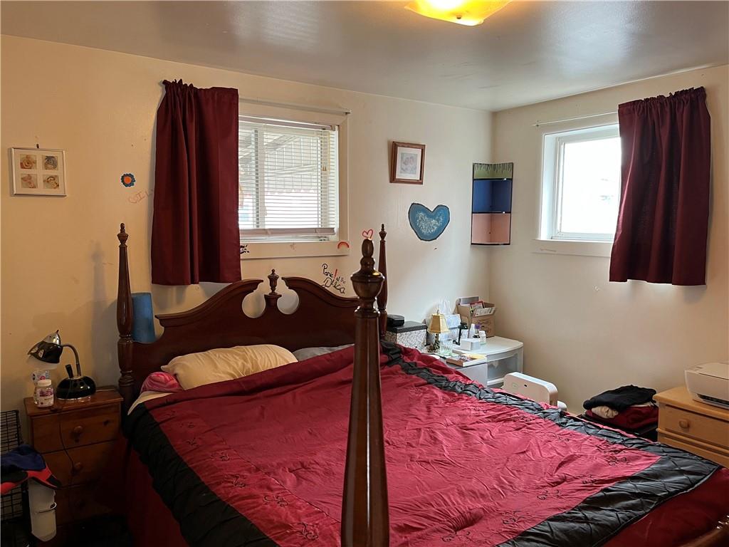 613-615 Bank Street Carnegie, PA 15106 - Photo 7 of 25 a bedroom with a bed and wooden floor