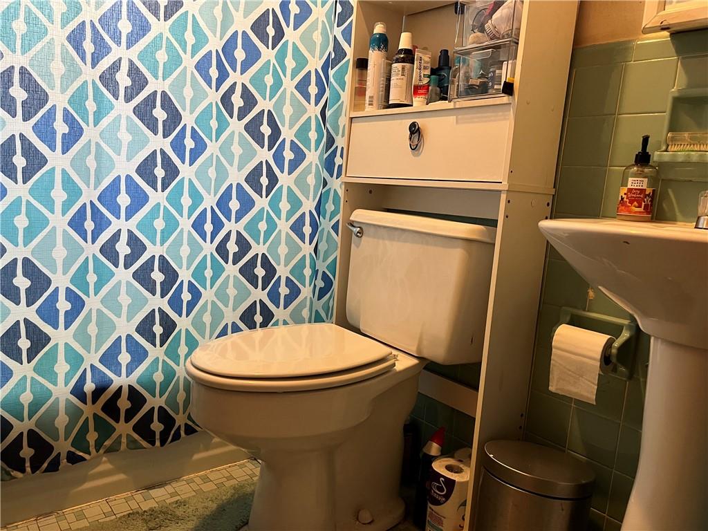 613-615 Bank Street Carnegie, PA 15106 - Photo 10 of 25 a white toilet sitting next to a shower curtain