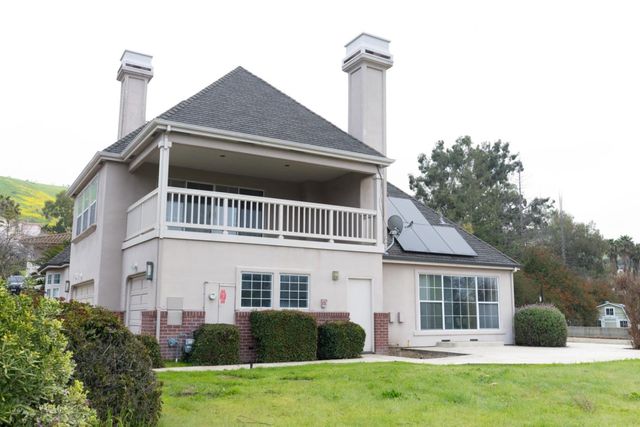 a hallway with wooden floor electronic appliances and wooden floor