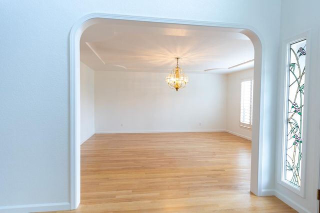 a kitchen with a wooden floor and a fireplace