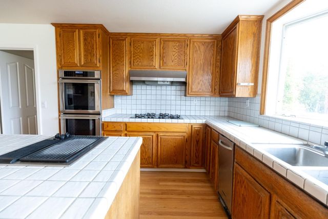 a bathroom with a white bath tub a toilet and a shower