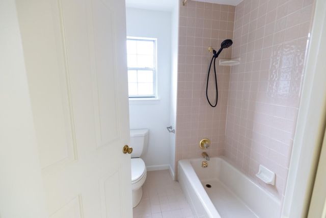 a bathroom with a tub a double vanity sink a mirror and a shower