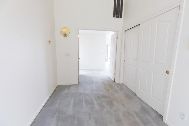 a kitchen with granite countertop wooden cabinets stainless steel appliances and a window
