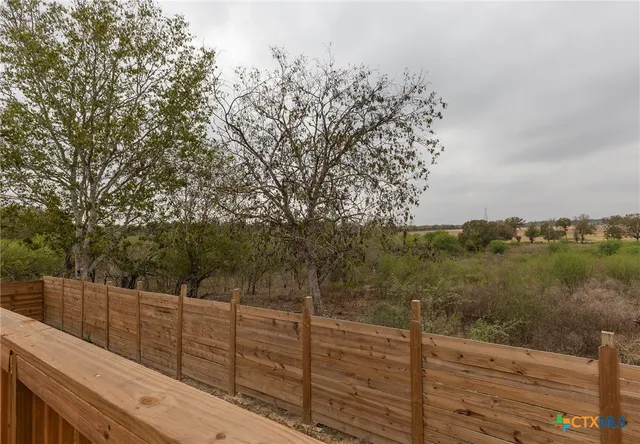 a view of a balcony and trees