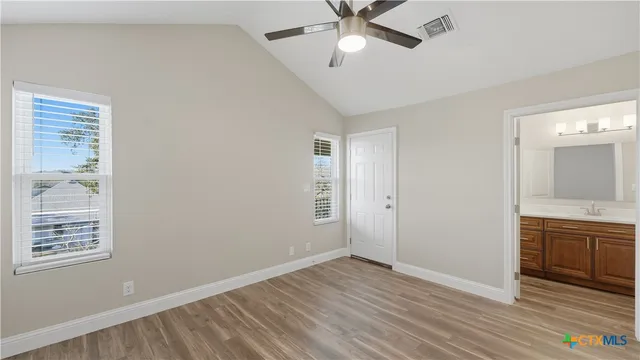 a bathroom with a sink a vanity and a tub