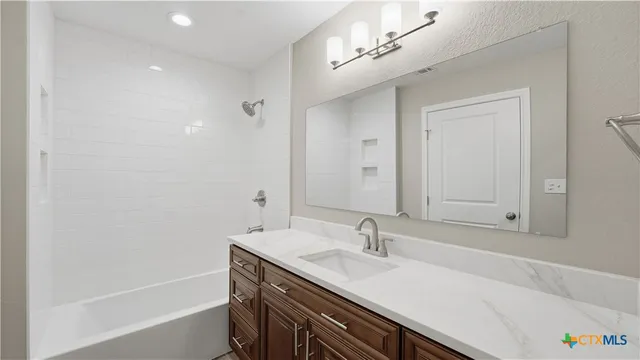 a bathroom with a bathtub and shower