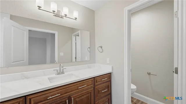 a bathroom with a double vanity sink and a mirror
