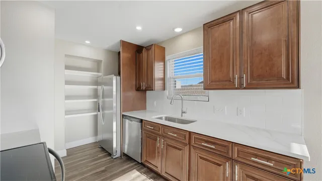 a kitchen with a sink and cabinets
