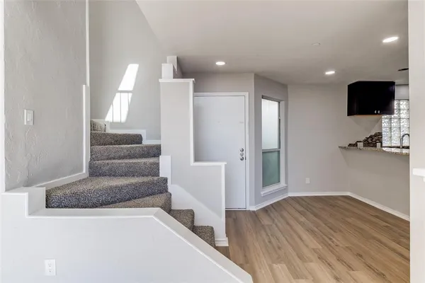 a view of a living room with furniture and a flat screen tv