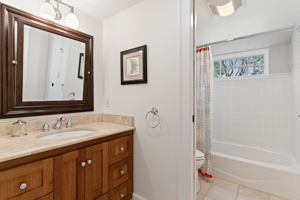 14 Winthrop Road Wayland, MA 01778 - Photo 17 of 25 a bathroom with a sink a mirror and a bathtub