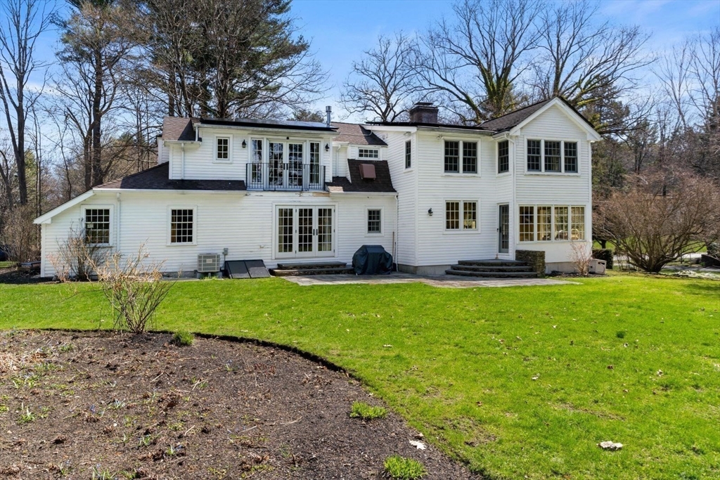 14 Winthrop Road Wayland, MA 01778 - Photo 22 of 25 a view of a white house with a big yard and large trees