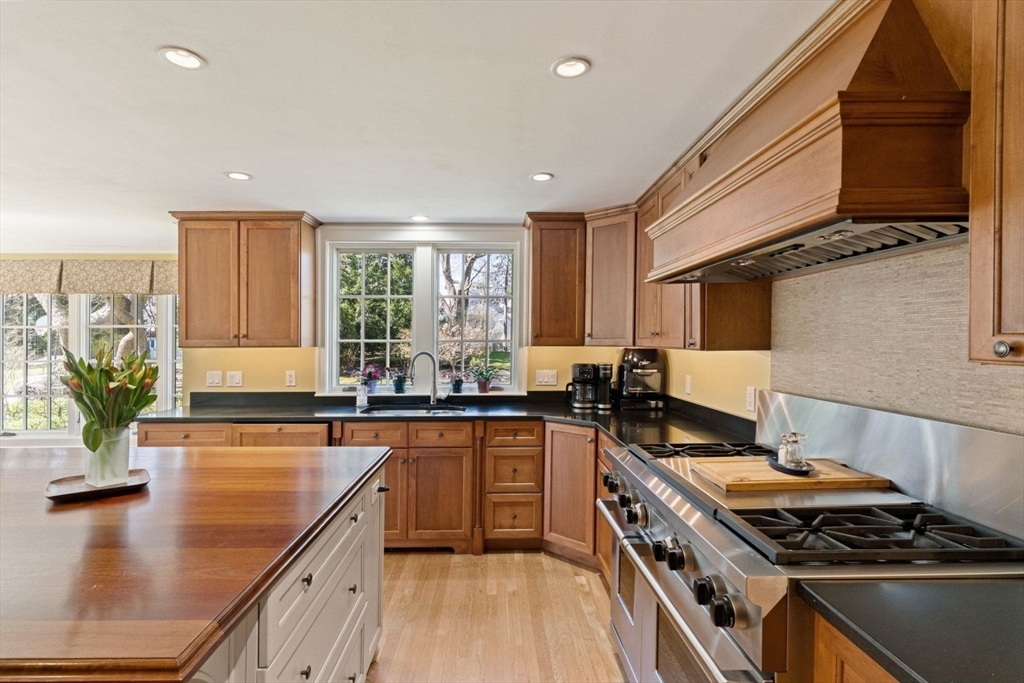 14 Winthrop Road Wayland, MA 01778 - Photo 3 of 25 a kitchen with stainless steel appliances granite countertop a stove a sink dishwasher and cabinets with wooden floor