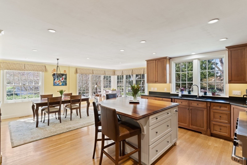 14 Winthrop Road Wayland, MA 01778 - Photo 4 of 25 a dining hall with stainless steel appliances granite countertop a stove a sink a dining table and chairs