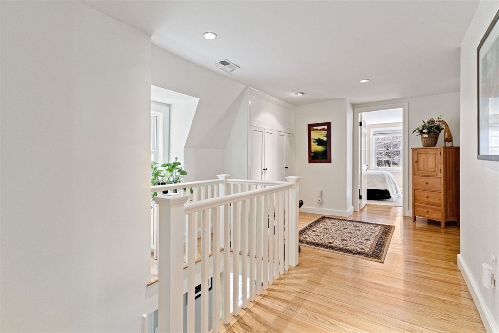 14 Winthrop Road Wayland, MA 01778 - Photo 9 of 25 a view of a hallway to a livingroom with wooden floor and furniture