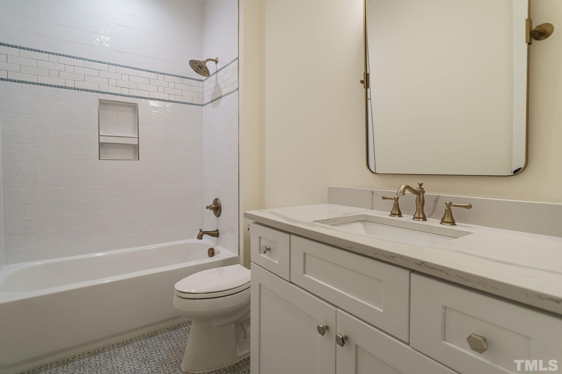 505 Harvey Street Raleigh, NC 27608 - Photo 26 of 31 a bathroom with a granite countertop sink a toilet and shower