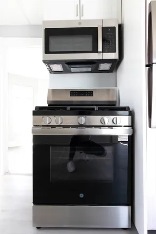a stove top oven sitting inside of a kitchen