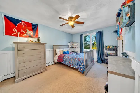 a bedroom with a bed and a dresser in it