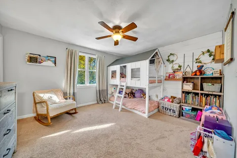 a living room with furniture and a gym machine
