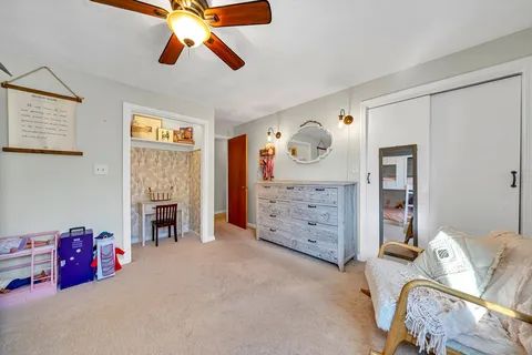 a bedroom with furniture and a fireplace