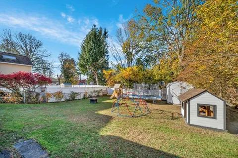 a view of a house with swimming pool and sitting area