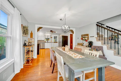 a view of a dining room with furniture and a chandelier