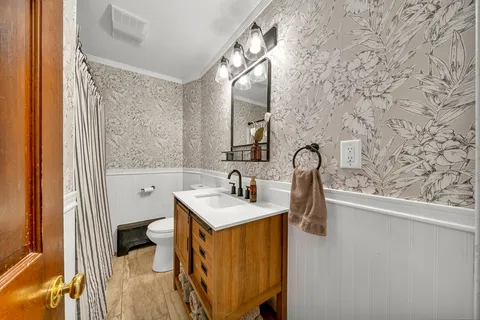 a bathroom with a sink a vanity and a mirror