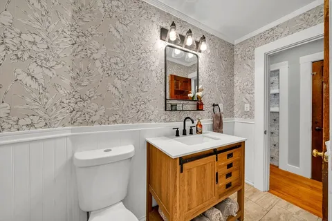 a bathroom with a sink a toilet and mirror